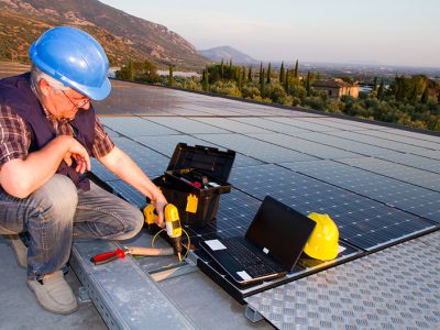 technician while working on a roof for a photovoltaic plant